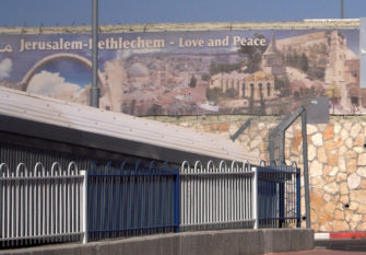 Jerusalem-Bethlehem militarized checkpoint with sign: "Love and Peace."