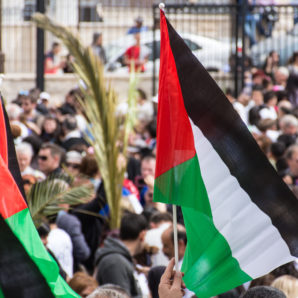Palm Sunday procession with Palestinian flags