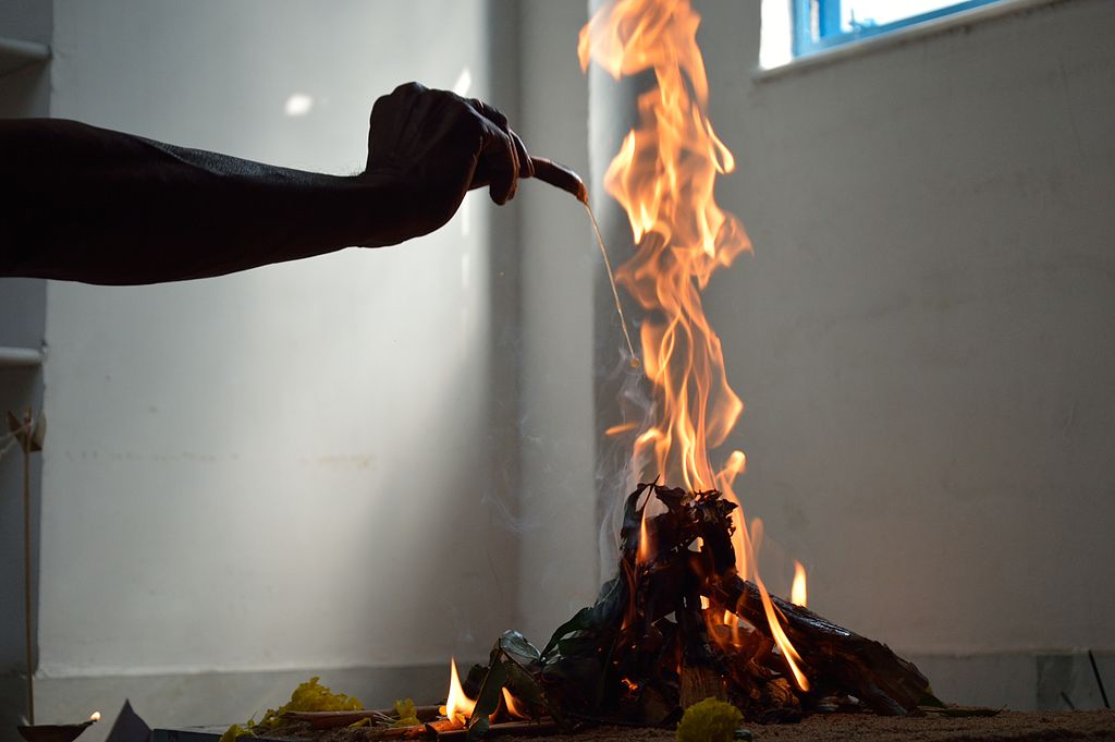Offering of ghee into Yajna Agni, the sacred sacrificial fire.